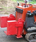 Red Boss stabilizers and counterweights on a walk-behind loader